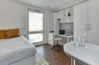 a bedroom with a bed and a desk with a computer at Liverpool Georgian Quarter in Liverpool