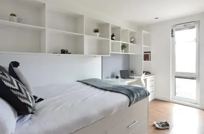 a white bedroom with a bed and a desk at Liverpool Georgian Quarter in Liverpool
