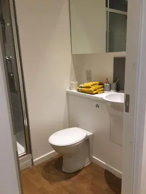 a white bathroom with a toilet and a sink at Liverpool Georgian Quarter in Liverpool