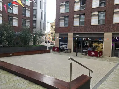 a street with a bench in front of a building at Liverpool Georgian Quarter in Liverpool