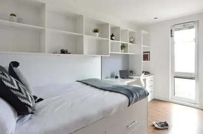a white bedroom with a bed and a desk at Liverpool Georgian Quarter in Liverpool