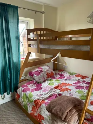 a bedroom with a bunk bed next to a window at Wavertree Accomodation in Liverpool
