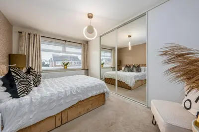 a bedroom with two beds and a large mirror at Everythings Rosey at Rosecroft in Ormskirk