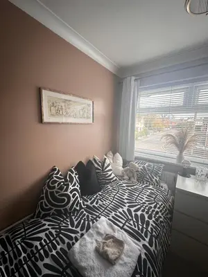 a bedroom with a black and white bed and a window at Everythings Rosey at Rosecroft in Ormskirk