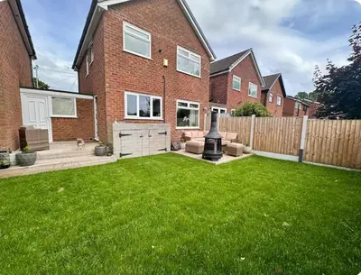 a yard with a house with a green lawn at Everythings Rosey at Rosecroft in Ormskirk