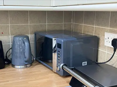 a microwave sitting on top of a kitchen counter at mater dei suite near royal liverpool hospital in Liverpool