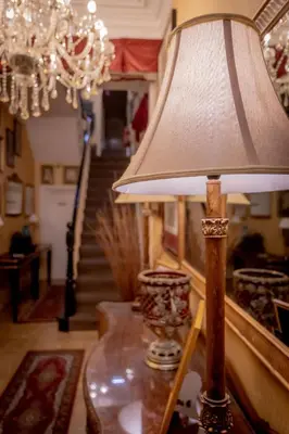 a lamp on a table in a room with a staircase at Hotel Rouge in Blackpool