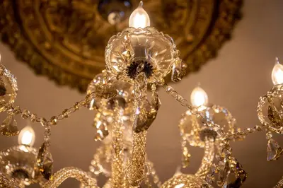a gold chandelier in front of a mirror at Hotel Rouge in Blackpool