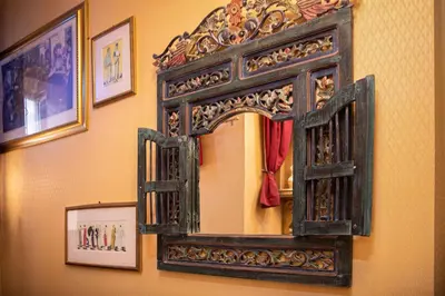 an antique mirror on a wall with pictures at Hotel Rouge in Blackpool