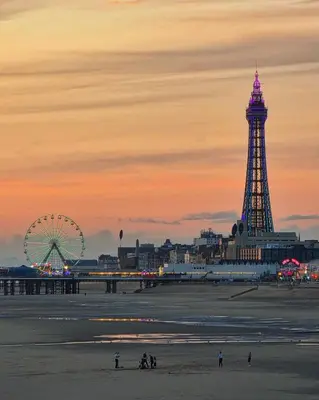 a beach with a ferris wheel and a ferris wheel at Hotel Rouge in Blackpool