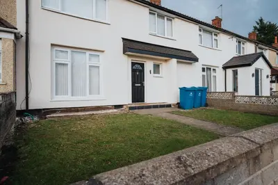a house with a lawn in front of it at Homestay in Knowsley