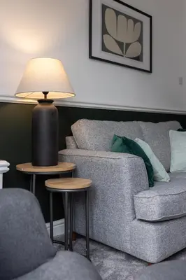 a living room with a couch and a lamp at Cowley House - Air Host & Stay - Sleeps 7 in Liverpool