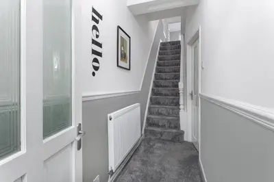 a staircase in a house with white walls at Cowley House - Air Host & Stay - Sleeps 7 in Liverpool