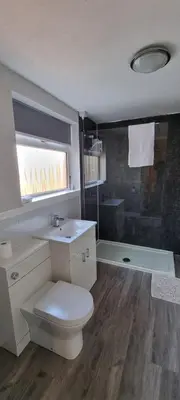 a bathroom with a toilet and a sink and a shower at A cozy home in Liverpool in Liverpool
