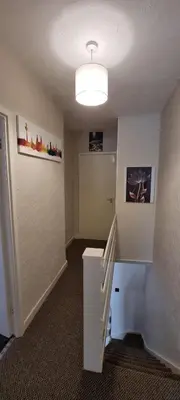 an empty room with a staircase and a light at A cozy home in Liverpool in Liverpool