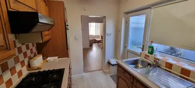 a kitchen with a sink and a counter top at A cozy home in Liverpool in Liverpool