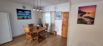 a dining room with a table and chairs and a refrigerator at A cozy home in Liverpool in Liverpool