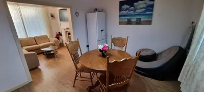 a living room with a table and chairs and a couch at A cozy home in Liverpool in Liverpool