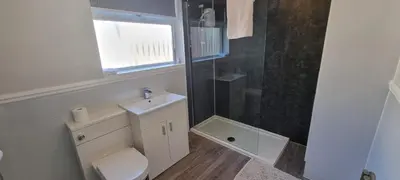 a bathroom with a toilet and a sink and a shower at A cozy home in Liverpool in Liverpool