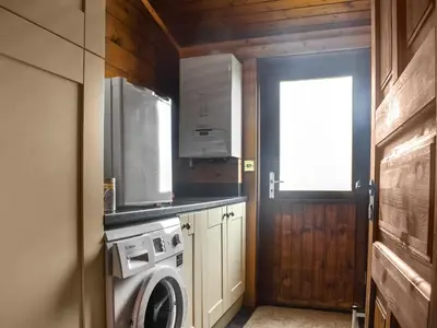 a kitchen with a washing machine and a window at Chestnut Lodge in Pilling