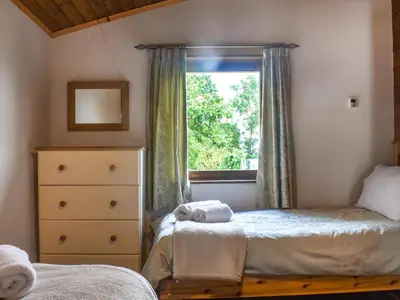 a bedroom with two beds and a window at Chestnut Lodge in Pilling