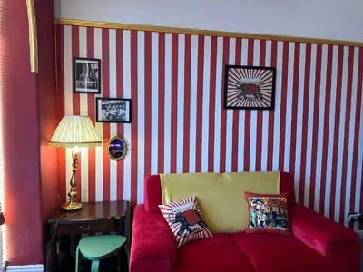 a living room with a red and white striped wall at Circus Suite Blackpool in Blackpool