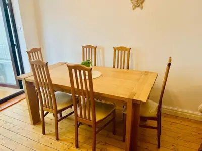 a wooden dining room table with four chairs and a table at Fairholmes House in Thornton