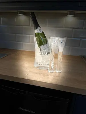 a bottle of champagne and two glasses on a counter at No1,luxury 1 bed apartment in Saint Annes on the Sea