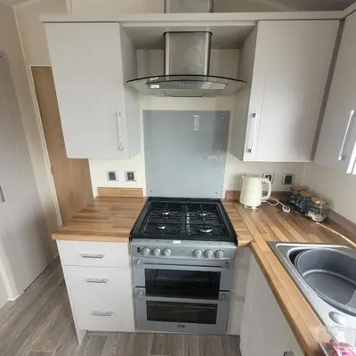 a kitchen with a stove and a sink at Beachside Lodge - Sleeps 6 - Pets ok - Parking in Morecambe