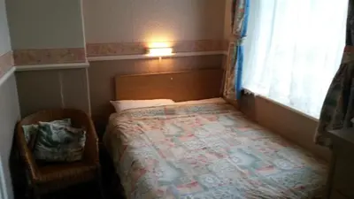 a small bedroom with a bed and a window at Walford Hotel in Blackpool