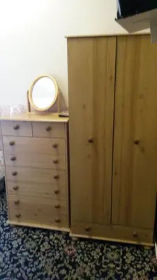 a bedroom with a dresser and a mirror on a cabinet at Walford Hotel in Blackpool