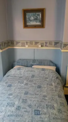 a bed in a bedroom with a picture on the wall at Walford Hotel in Blackpool