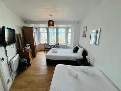 a hotel room with two beds and a television at Henson hotel in Blackpool