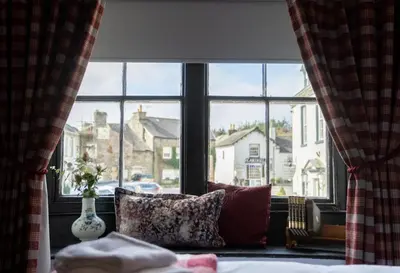a window with a view of a city from a bedroom at The Kings Arms in Cartmel
