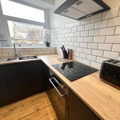 a kitchen with a counter top and a sink at MOREaccom Maisonette in Morecambe