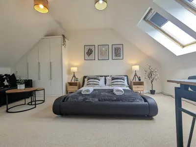 a bedroom with a large bed in a attic at Large 4-Bedrooms House Near Centre Free Parking in Liverpool