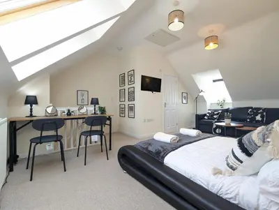 a bedroom with a bed and a desk with chairs at Large 4-Bedrooms House Near Centre Free Parking in Liverpool