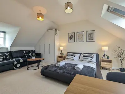 a bedroom with a large bed and a couch at Large 4-Bedrooms House Near Centre Free Parking in Liverpool