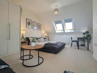 a living room with a bed and a table at Large 4-Bedrooms House Near Centre Free Parking in Liverpool