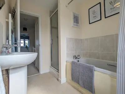 a bathroom with a sink and a bath tub at Large 4-Bedrooms House Near Centre Free Parking in Liverpool