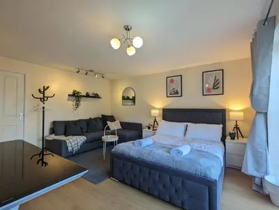 a living room with a couch and a living room with a bed at Large 4-Bedrooms House Near Centre Free Parking in Liverpool