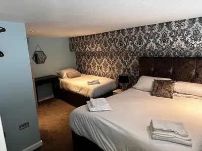 a hotel room with two beds with towels on them at 5 Halifax House, apartment 3 in Liverpool