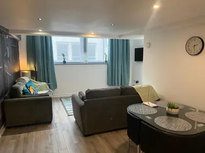 a living room with a couch and a table at 5 Halifax House, apartment 3 in Liverpool