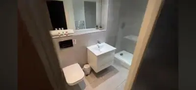 a bathroom with a white sink and a toilet at 5 Halifax House, apartment 3 in Liverpool