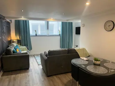 a living room with a couch and a table at 5 Halifax House, apartment 3 in Liverpool