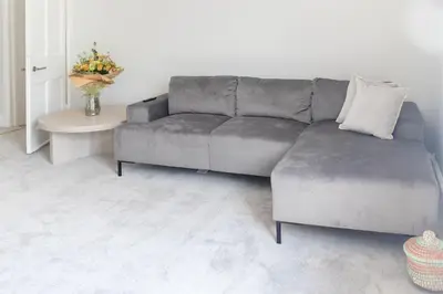 a living room with a gray couch and a table at No 45 Roscoe St in Liverpool