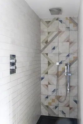 a bathroom with a shower with blue and white tiles at No 45 Roscoe St in Liverpool