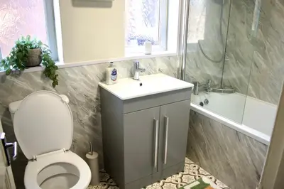 a bathroom with a toilet and a sink and a shower at Spacious Flats in St Helens, Merseyside in Saint Helens