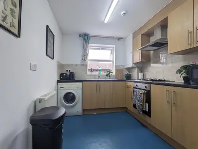 a kitchen with a washing machine and a window at Room Near City Centre Private Bath Free Parking in Liverpool