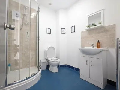 a bathroom with a shower and a toilet and a sink at Room Near City Centre Private Bath Free Parking in Liverpool
